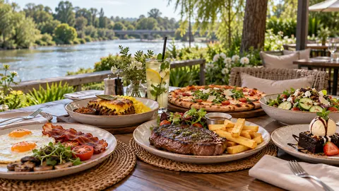 Riverside table with breakfast, steak, pizza and dessert at O’s Restaurant Parys